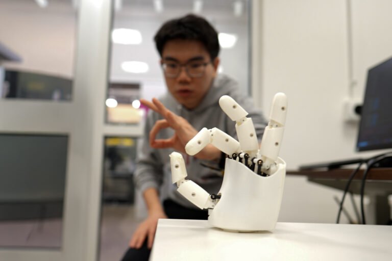 Wristband enables wearers to control a robotic hand with their own movements | MIT News